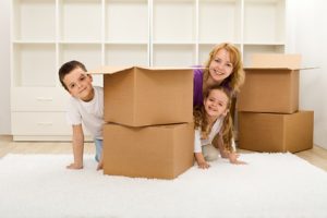 Happy kids and woman in a new home